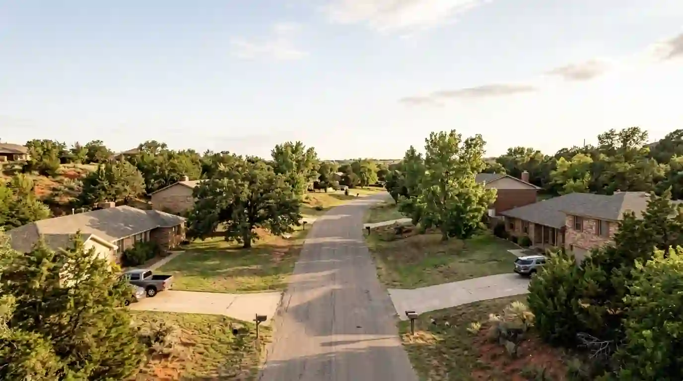 Residential street in Lake Tanglewood Texas with brick and frame homes